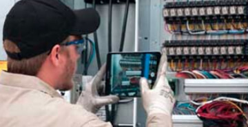 Technician using a tablet to take images at a job-site